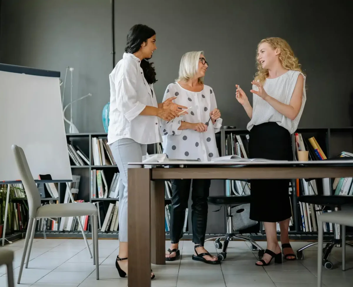 a group of women standing around a table